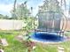 Well-maintained backyard with fresh plantings, brick pavers, and a trampoline at 1672 Canoe Creek Rd, Oviedo, FL 32766