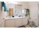 Bright bathroom with dual sinks, decorative accents, and ample lighting at 1672 Canoe Creek Rd, Oviedo, FL 32766