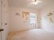 Bright bedroom features neutral carpet, window, ceiling fan and closet with safari-themed wall decor at 1672 Canoe Creek Rd, Oviedo, FL 32766
