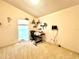 Office-style bedroom with plush carpeting, natural light, and shelves with personal effects at 1672 Canoe Creek Rd, Oviedo, FL 32766
