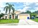 Exterior shot of a charming single-story home with a well-maintained lawn and attached two-car garage at 1672 Canoe Creek Rd, Oviedo, FL 32766