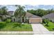 Charming single-Gathering home with well-manicured lawn, mature trees, and a spacious driveway at 1672 Canoe Creek Rd, Oviedo, FL 32766