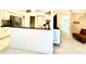 Open concept kitchen with granite countertops, white cabinetry, and stainless steel appliances, connecting to living area at 1672 Canoe Creek Rd, Oviedo, FL 32766