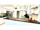 Well-lit kitchen features granite countertops, white cabinetry, and stainless steel appliances for modern living at 1672 Canoe Creek Rd, Oviedo, FL 32766