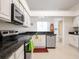 Bright kitchen featuring white cabinetry, granite countertops, stainless steel appliances, and a stainless dishwasher at 1672 Canoe Creek Rd, Oviedo, FL 32766