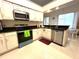 Bright kitchen with white cabinets, stainless steel appliances, and granite countertops, perfect for cooking at 1672 Canoe Creek Rd, Oviedo, FL 32766
