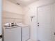 Functional laundry room featuring a washer, dryer, and wire shelving for storage and organization at 1672 Canoe Creek Rd, Oviedo, FL 32766