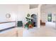 Airy living room with neutral walls, modern decor, arched doorways, and abundant natural light at 1672 Canoe Creek Rd, Oviedo, FL 32766