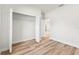Bedroom boasts an open closet and light hardwood flooring with a view of another room at 178 Marion Oaks Ln, Ocala, FL 34473