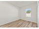 Small bedroom space with hardwood floors, white trim, and a window with natural light at 178 Marion Oaks Ln, Ocala, FL 34473