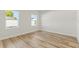 A bright bedroom space featuring hardwood flooring, natural light, and neutral walls at 178 Marion Oaks Ln, Ocala, FL 34473