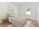 Small staged bedroom features hardwood floors, a night stand, and simple decorations at 178 Marion Oaks Ln, Ocala, FL 34473
