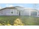 Well-maintained one-story home with a gray facade, fresh green lawn, and an attached garage at 178 Marion Oaks Ln, Ocala, FL 34473