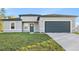 Charming single-story home with modern design, manicured lawn, and attached two-car garage at 178 Marion Oaks Ln, Ocala, FL 34473