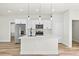 Modern kitchen features stainless appliances, white cabinets, island with breakfast bar, and sleek fixtures at 178 Marion Oaks Ln, Ocala, FL 34473