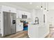 Modern kitchen features stainless steel refrigerator and appliances, white cabinets, and island with counter seating at 178 Marion Oaks Ln, Ocala, FL 34473