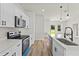 Bright kitchen boasts stainless steel appliances, island with sink, quartz counters, and modern black hardware at 178 Marion Oaks Ln, Ocala, FL 34473