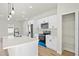 New kitchen features white cabinets, stainless steel appliances, quartz counters, pantry, and island with bar seating at 178 Marion Oaks Ln, Ocala, FL 34473