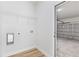 Laundry room leading to the garage features white trim, hardwood flooring, and ample space at 178 Marion Oaks Ln, Ocala, FL 34473