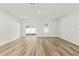 Spacious and bright living area with hardwood flooring, a sliding glass door, and white walls at 178 Marion Oaks Ln, Ocala, FL 34473