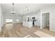 Open living space showcasing the kitchen with an island and bar seating, and modern pendant lighting at 178 Marion Oaks Ln, Ocala, FL 34473