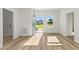 Bright living room featuring hardwood floors, white walls, and ample natural light from the windows at 178 Marion Oaks Ln, Ocala, FL 34473