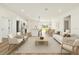 Stylishly furnished living room with modern seating, a kitchen island, and a bright dining area at 178 Marion Oaks Ln, Ocala, FL 34473