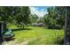 A large, grassy backyard with trees and a chicken coop at 19951 Quinlan St, Orlando, FL 32833
