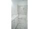 Sleek, renovated bathroom with luxurious marble tile, a soaking tub, and a modern vanity for a spa-like experience at 19951 Quinlan St, Orlando, FL 32833