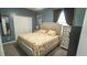 Blue bedroom showcases a queen-sized bed, natural lighting, and calm decor to make a comfortable and restful retreat at 19951 Quinlan St, Orlando, FL 32833