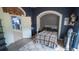 Comfortable bedroom with plaid blanket on bed, archway entrance, textured wall decor, and soothing dark blue walls at 19951 Quinlan St, Orlando, FL 32833