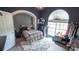 Cozy bedroom with a large arch window, plush rug, dark blue walls, and unique decor at 19951 Quinlan St, Orlando, FL 32833