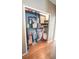 Walk-in closet with custom shelving, organized clothing, and hardwood floors, providing ample storage space and functionality at 19951 Quinlan St, Orlando, FL 32833