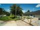 Driveway with a white gate leading to the house, parked cars on the side of the road at 19951 Quinlan St, Orlando, FL 32833