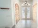 Elegant entryway featuring double doors, tile flooring, and decorative wall paneling at 19951 Quinlan St, Orlando, FL 32833