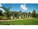 Well maintained home with a walkway, lush landscaping, manicured lawn, and symmetrical facade at 19951 Quinlan St, Orlando, FL 32833