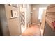 Hallway leads to a bathroom, showcasing hardwood flooring, neutral paint, and stylish decor elements for a cohesive design at 19951 Quinlan St, Orlando, FL 32833