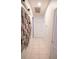 Hallway with tile floor and wooden art on the wall leading to multiple rooms at 19951 Quinlan St, Orlando, FL 32833