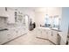 Bright kitchen with white cabinets, island, stainless steel appliances, and pendant lighting at 19951 Quinlan St, Orlando, FL 32833