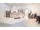 Bright kitchen with stainless steel refrigerator, white cabinets, and expansive marble countertop island at 19951 Quinlan St, Orlando, FL 32833