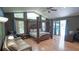 Expansive main bedroom features a four-poster bed, a sitting area, and lots of natural light at 19951 Quinlan St, Orlando, FL 32833