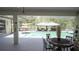 Covered patio features an outdoor dining table and view of the pool and gazebo in backyard at 19951 Quinlan St, Orlando, FL 32833
