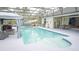 A screened-in pool with covered seating and an outdoor dining area at 19951 Quinlan St, Orlando, FL 32833