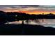 Backyard view overlooking a pond at sunset at 2400 Addison Creek Dr, Kissimmee, FL 34758
