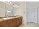 Bathroom featuring double sinks, updated countertops, and a glass enclosed shower at 2400 Addison Creek Dr, Kissimmee, FL 34758