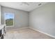 Empty bedroom with neutral carpet, light-colored walls, and bright window at 2400 Addison Creek Dr, Kissimmee, FL 34758