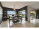 Dining area with a table, chairs, bench, modern light fixture, and sliding glass doors at 2400 Addison Creek Dr, Kissimmee, FL 34758