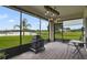 Screened lanai overlooking a peaceful pond, featuring a modern fire pit and hanging lights at 2400 Addison Creek Dr, Kissimmee, FL 34758