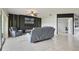 Spacious living room featuring a modern fireplace, ceiling fan, and tile flooring at 2400 Addison Creek Dr, Kissimmee, FL 34758