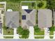 Aerial view of homes, highlighting the neighborhood layout with well-maintained lawns, driveways, and solar panels at 2409 Martins Run, Tavares, FL 32778